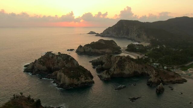 Rugged Cliffs At Beach Maruata In Michoacan At Sunset In Mexico - aerial shot