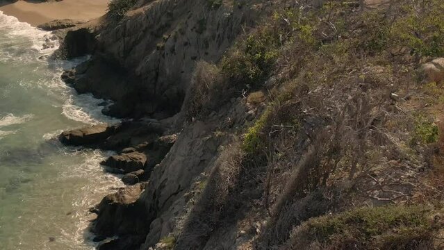 Wildlife Scene At The Rocky Island Of Faro de Bucer&iacute;as, Playa Maroma In Michoacan, Mexico. Aerial Drone Shot