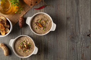 Soup, topinamburu cream.  Served with croutons in gray bowls.