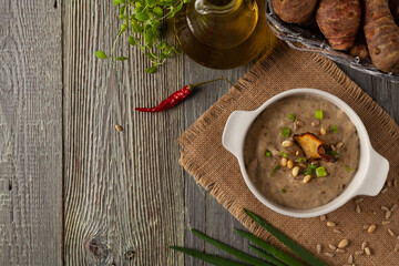 Soup, topinamburu cream.  Served with croutons in gray bowls.
