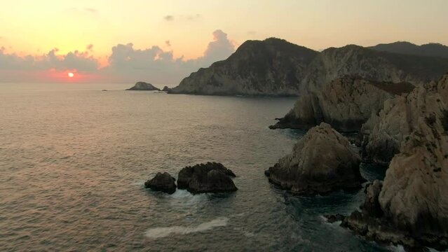Aerial View Of Maruata Beach With Cliffs And Rock Formations During Sunset In Michoacan, Mexico - drone shot