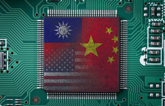China Taiwan and USA flag print screen to microchip on electronic board for symbol of military conflict war and economic business partnership concept.