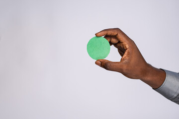 black man holding blank small cardboard circle for emoji face