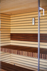 Modern wooden interior of beautiful and clean sauna with electric heater.