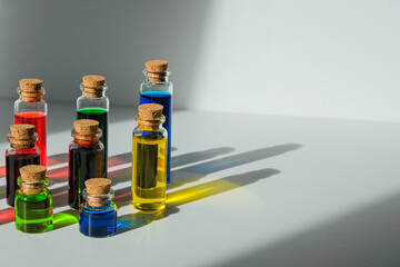 Side view of vials with a substance of different colors. Bright jars on a white background.