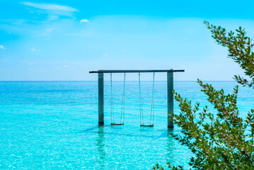 view on a tropical swing in water in the sea in the Maldives