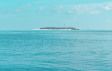 view from sea to island and water villas at day time with blue sky and beautiful clouds in the Maldives, the concept of luxury travel