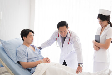 Obraz premium Doctor in professional working uniform taking care his patient and diagnosis symptoms on the bed.