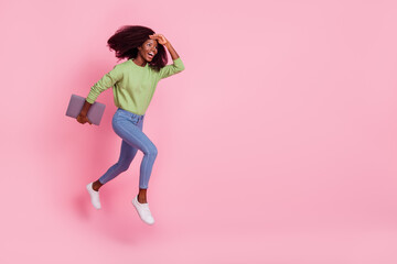 Fototapeta na wymiar Full length photo of impressed girl dressed green pullover running holding device looking far away empty space isolated pink color background