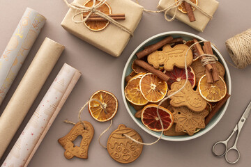 Preparing to decorate your home for Christmas, gift paper and dry citrus fruits with gingerbread...