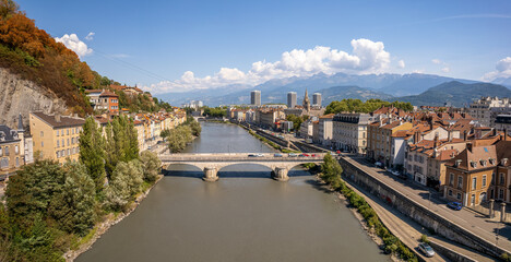 Fototapeta na wymiar The drone aerial view of the Isère river and Grenoble city, France. Grenoble is the prefecture and largest city of the Isère department in the Auvergne-Rhône-Alpes region.