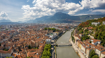 The drone aerial view of the Isère river and Grenoble city, France. Grenoble is the prefecture and...