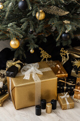 Naklejka na ściany i meble Home interior with decorated Christmas tree in black and gold colors and gifts under it, Merry Christmas and Happy New Year
