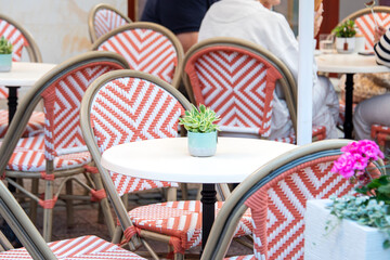 Empty table in outdoor cafe or restaurant. Tables and chairs at sidewalk cafe. Touristic setting, cafe table, sidewalk cafe furniture.