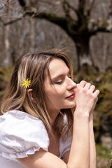 Fototapeta premium woman in white dress sitting in the forest pensive