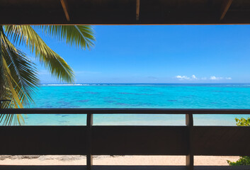 Window to tropical island beach with coconut palm branch, turquoise water and blue sky. Its time to have a vacation concept. Travel tourism background