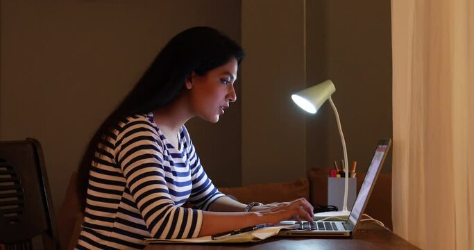 Young tired girl sleeping on study table after online class at home