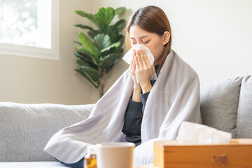 Sick, influenza asian young woman have a fever, flu hand in use tissues paper sneezing runny nose...