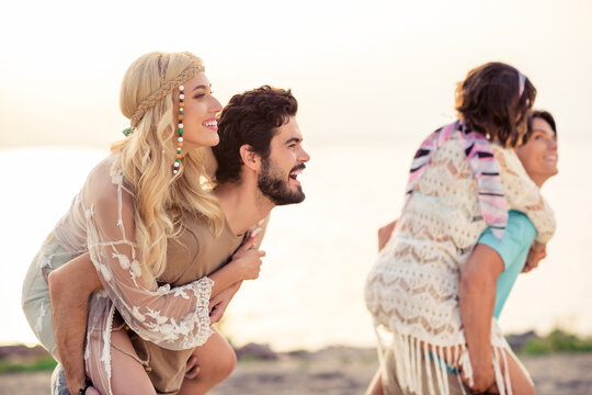 Photo of adorable dreamy hippie people company smiling having fun together outside seaside beach