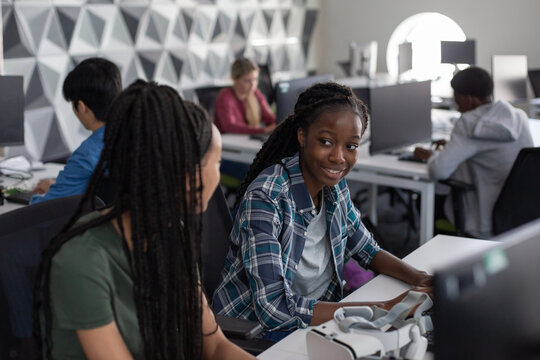 Female high school students computer programming in class