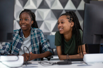 Female students learning how to code in class