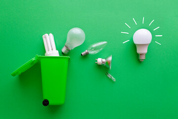 Saving electricity concept: bright new energy saving led lightbulb versus diverse old inefficient...