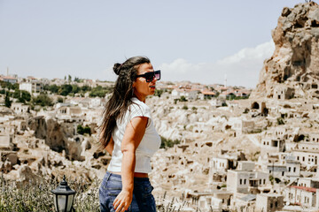 Back view of young  Happy tourist woman enjoying and photographing  the beautiful  Pigeon valley in...