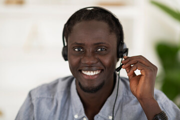 Hotline Operator. Portrait Of Smiling Black Man In Headset Looking At Camera
