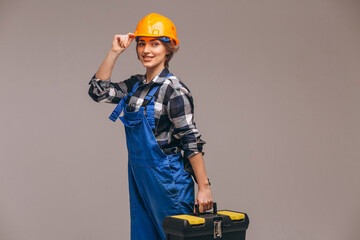 Woman repairer wearing overalls uniform and holding repair tool box