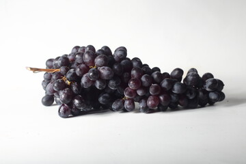 black grapes isolated on light background