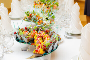 A sumptuously served buffet. Desserts, cakes, snacks on the tables. Restaurant business, catering.