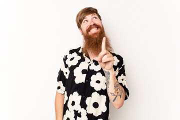 Young caucasian red-haired man isolated on white background indicates with both fore fingers up...