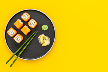 Salmon sushi rolls set on plate, top view. Japanese cuisine