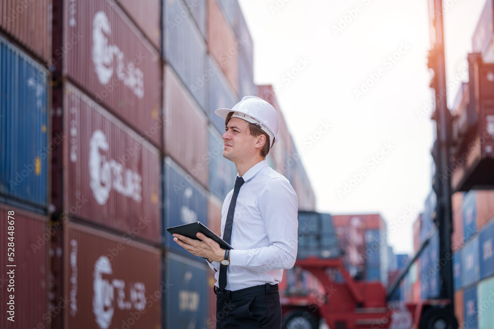 Poster Manager checking stock into container for loading at container yard warehouse,Logistic shipping yard business.