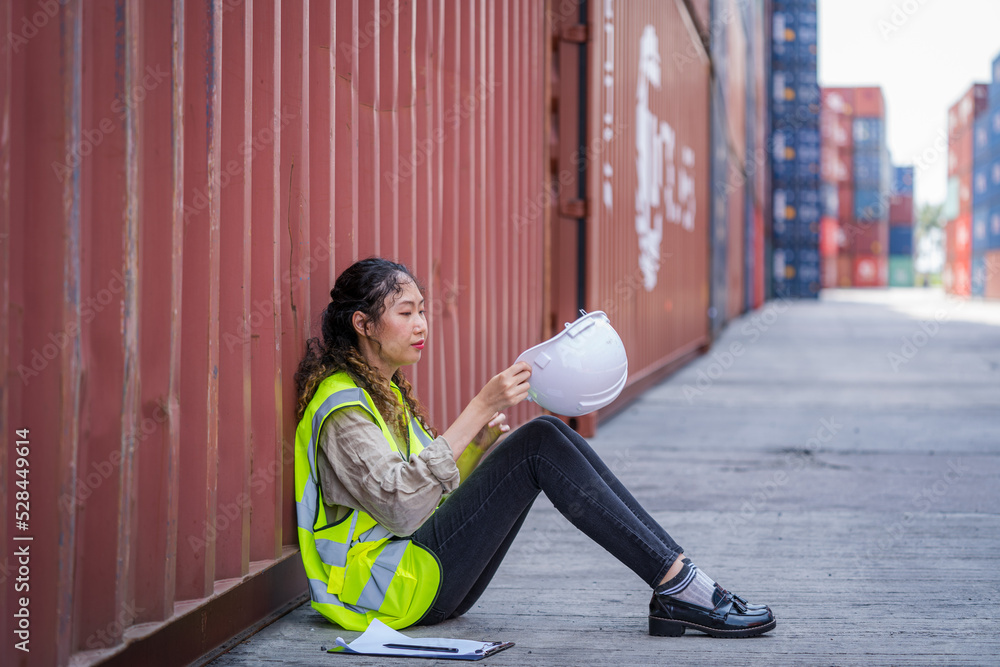 Poster Container yard worker sitting at container box and rest.