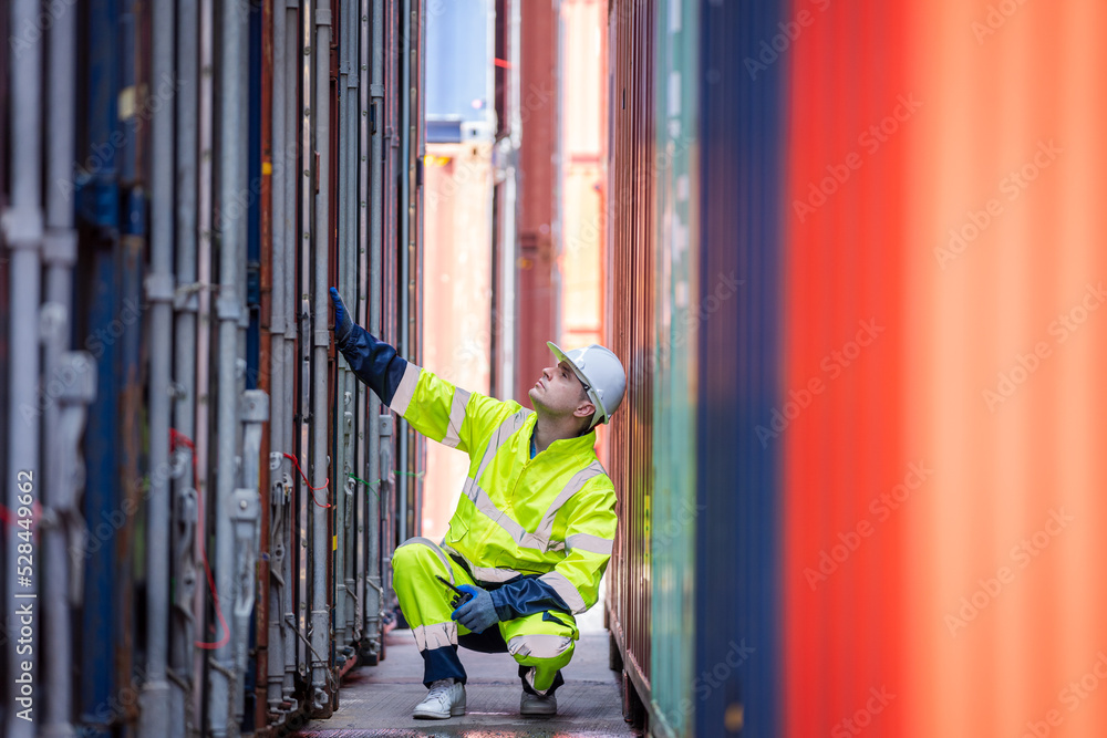 Poster Engineer working in shipping container in Container Terminal,Container in export and import business and logistics.