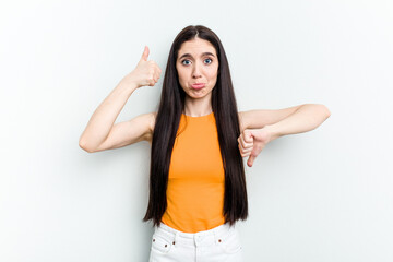 Young caucasian woman isolated on white background showing thumbs up and thumbs down, difficult choose concept