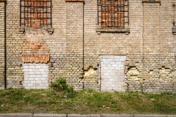 Old abandoned wall with bricked up windows