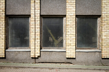Aged street wall with some windows