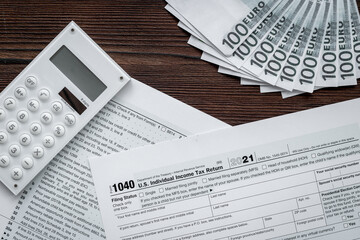 Annual tax form under US law with culculator. Tax payment concept