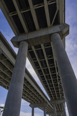 Obraz premium View Underneath a Large Bridge Highway on a Sunny Day with Blue Sky