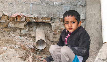 a child with a sad expression cause of flood and homelessness situation - obrazy, fototapety, plakaty