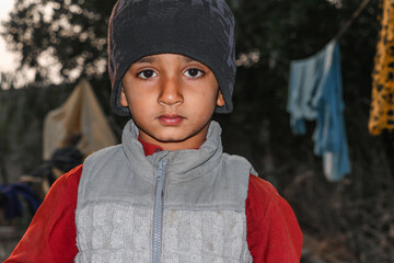 a child with a sad expression cause of flood and homelessness situation