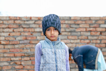 a child with a sad expression cause of flood and homelessness situation - obrazy, fototapety, plakaty
