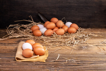 Chicken eggs laid on a wooden table on a rural farm