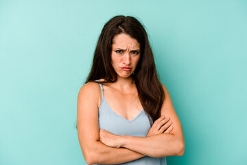 Young caucasian woman isolated on blue background unhappy looking in camera with sarcastic expression.