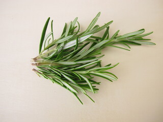 A small bouquet with fresh rosemary on a wooden board