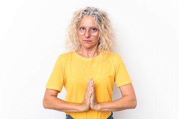Middle age caucasian woman isolated on white background praying, showing devotion, religious person...