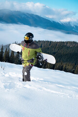 Fototapeta na wymiar man snowboarder portrait carpathian mountains on background
