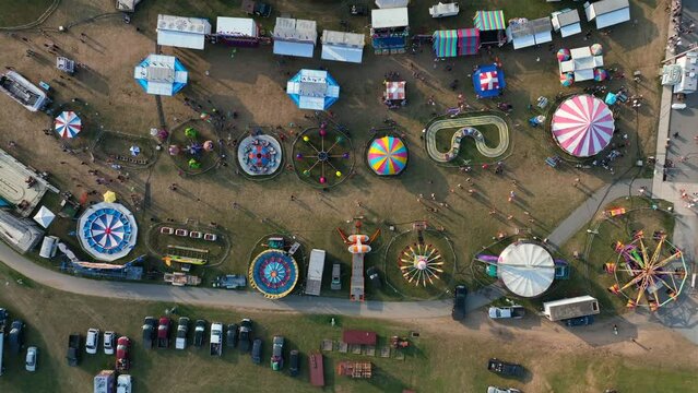 Colorful carnival rides. Top down aerial of fair festival at fairgrounds in USA.